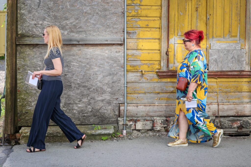 Two people walking during an interactive outdoor history experience in Parnu old town